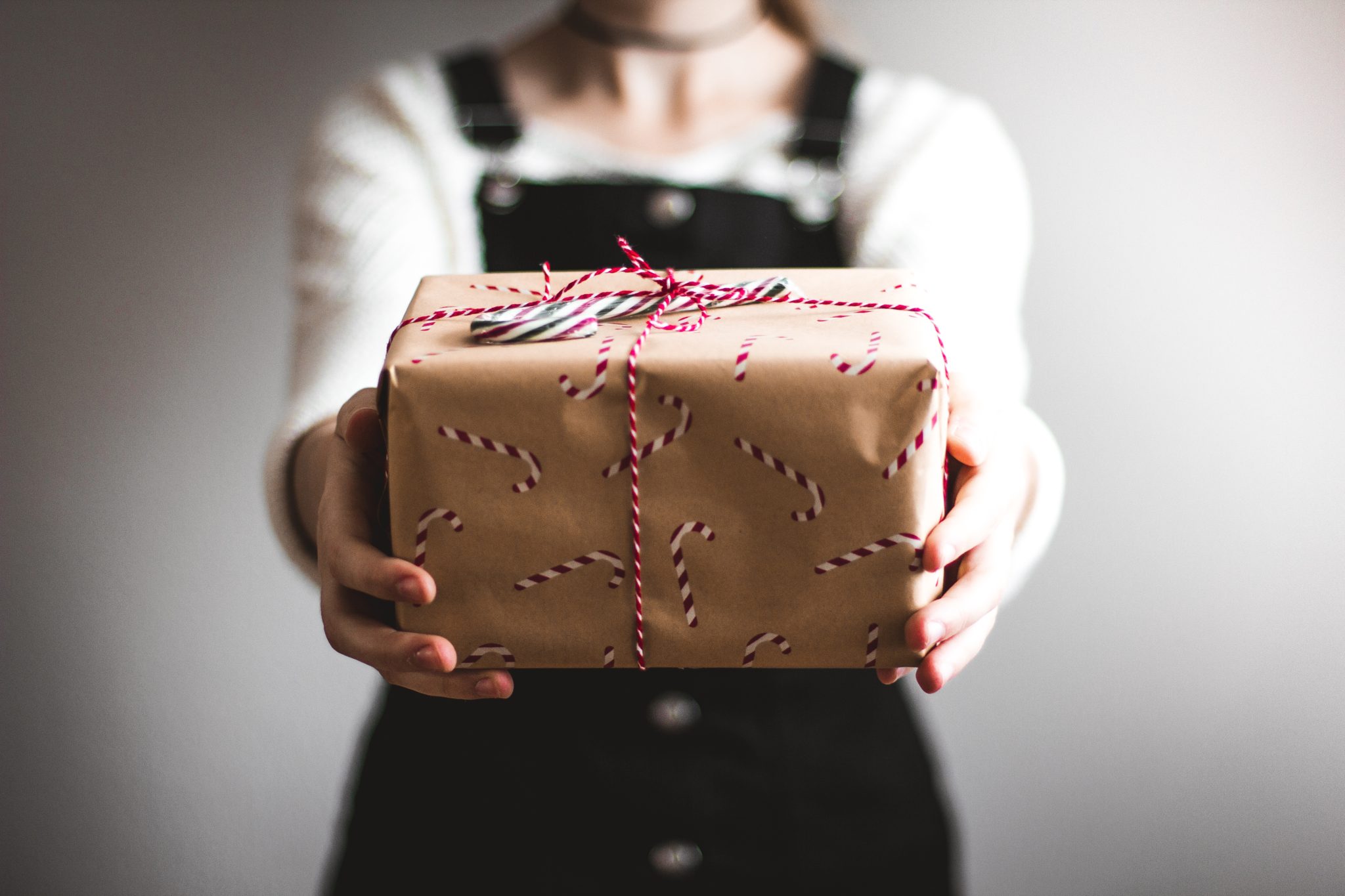 person holding a brown wrapped gift